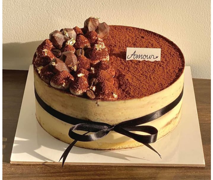 Tiramisu anniversary cake with chocolate and ribbon finish